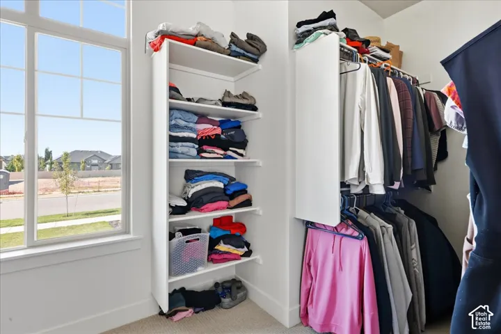 Built-in shelving, white trim window, and neutral wall color