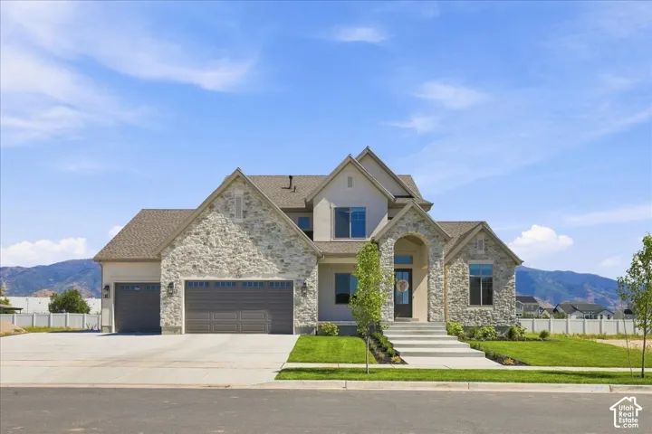 Stone and stucco exterior with a multi-gabled roofline