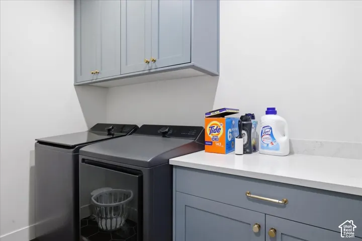Built-in cabinetry with gold-toned hardware, white countertop, and hexagonal floor tiling