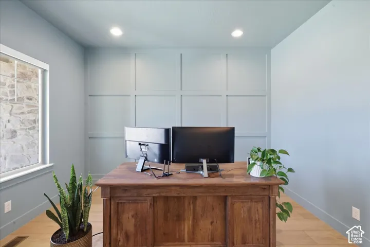 Recessed lighting, light wood-finish flooring, and board and batten accent wall