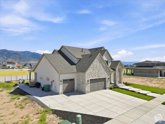 Stone and stucco exterior with a multi-gabled roofline