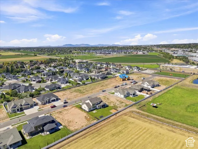 Established neighborhood setting with a mix of completed and developing properties, featuring paved streets and manicured lawns