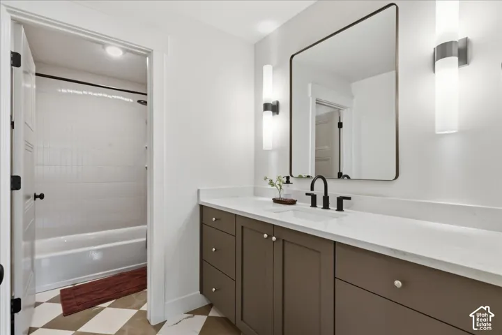 Single vanity with a white countertop, rectangular basin, and matte black faucet