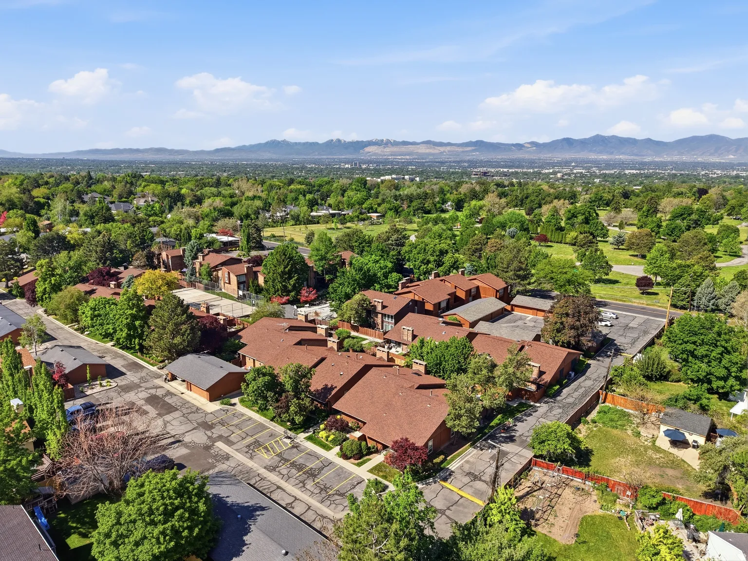 Expansive residential complex featuring multiple buildings with red-toned roofs