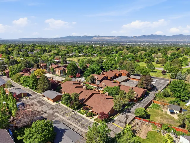 Expansive residential complex featuring multiple buildings with red-toned roofs