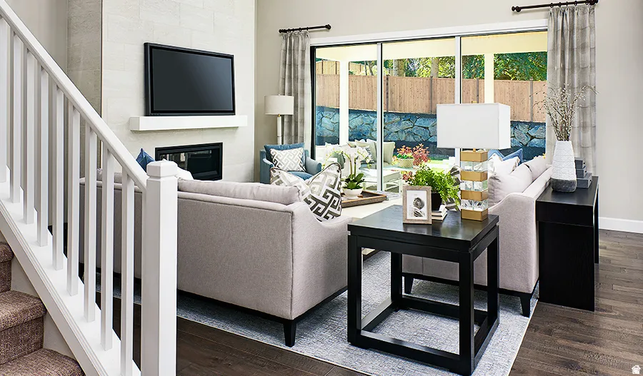 Living area with a fireplace, a wood mantle, and sliding glass doors to the exterior