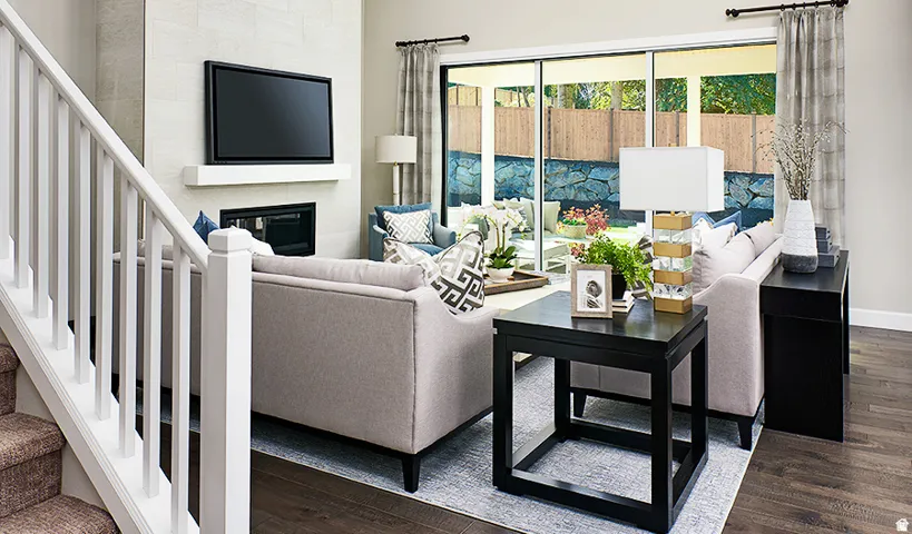 Living area with a fireplace, a wood mantle, and sliding glass doors to the exterior