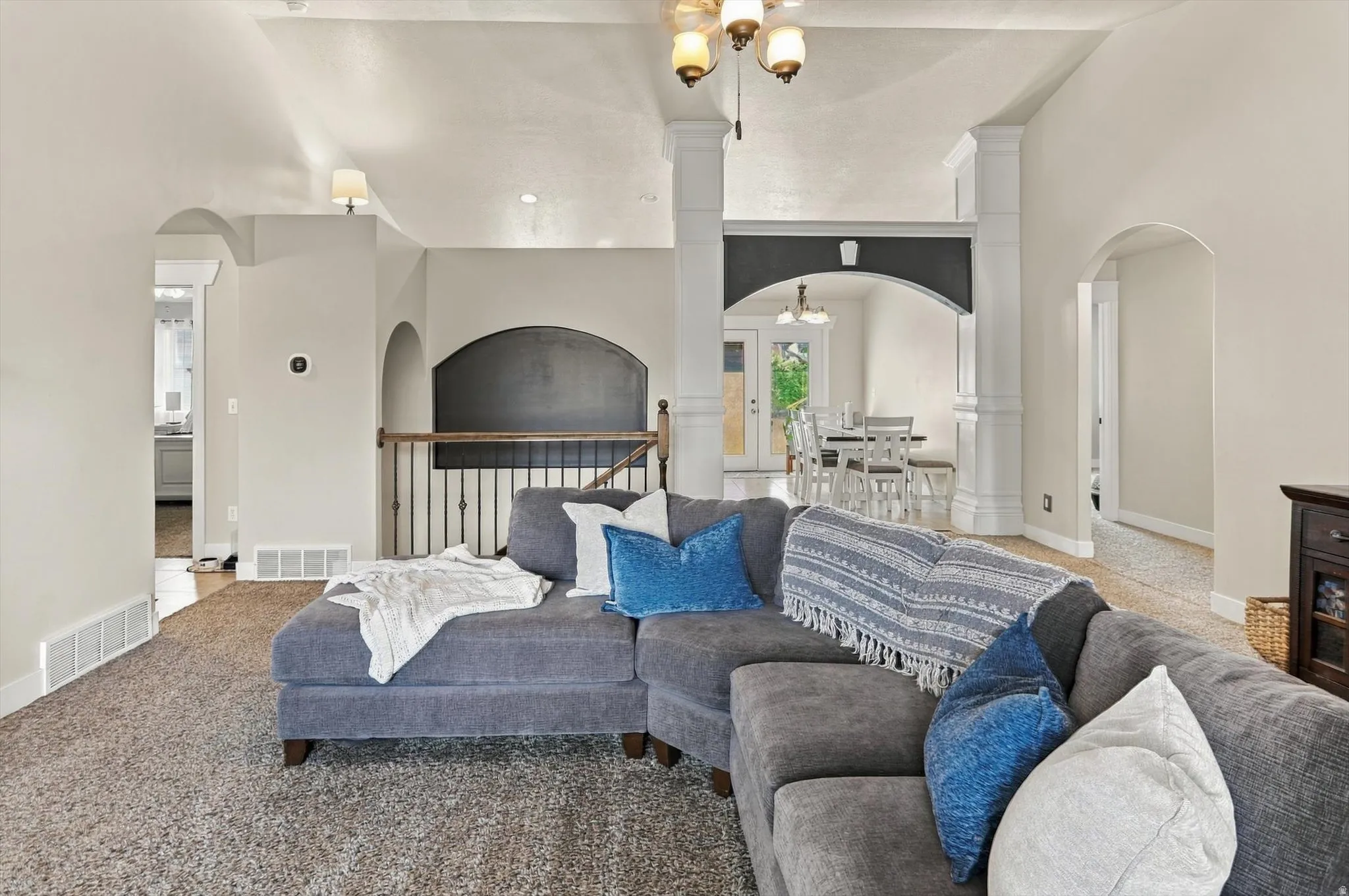 Arched doorways, decorative columns, and recessed lighting
