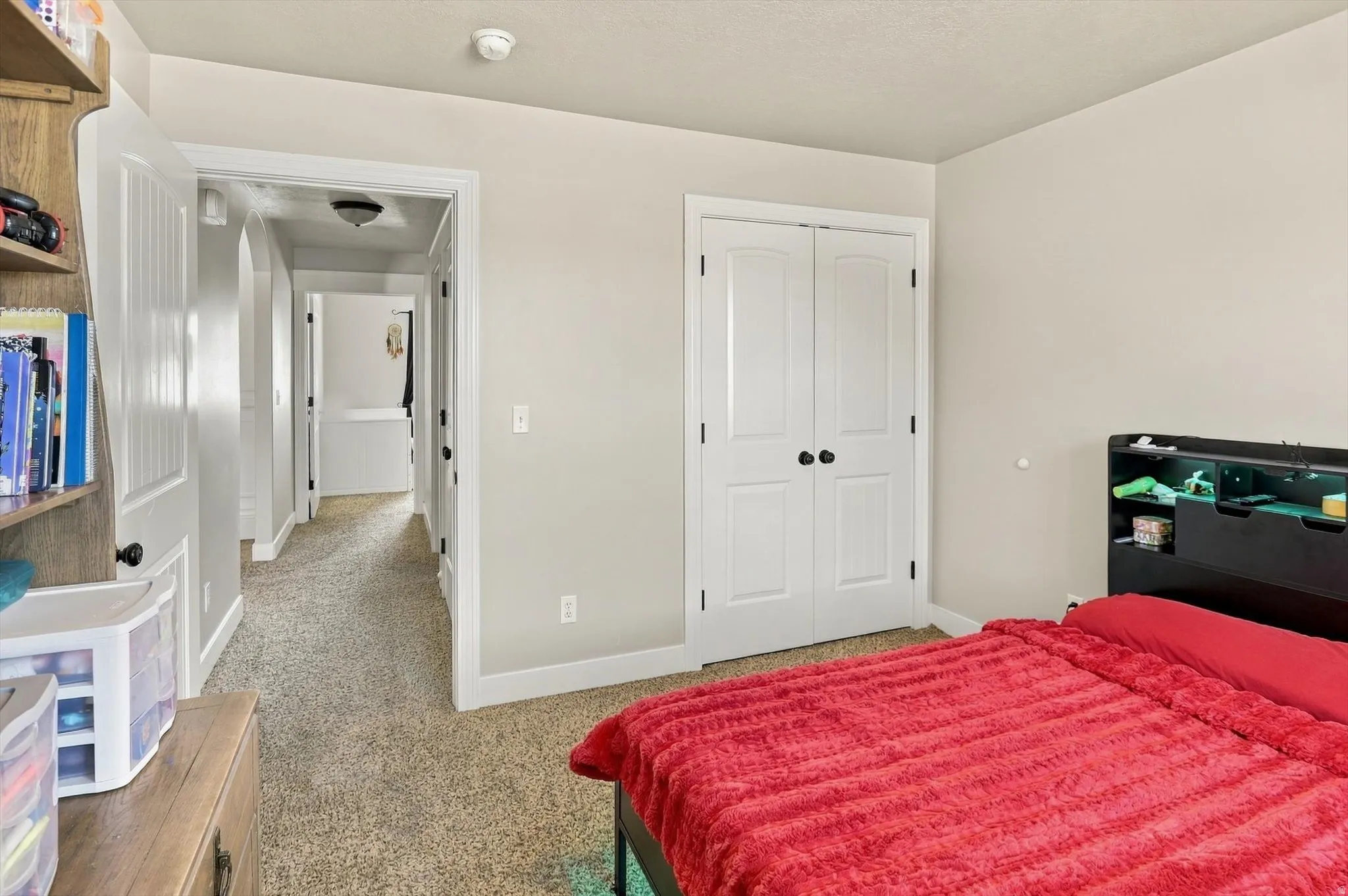 Carpeted flooring, neutral wall tones, and white trim throughout