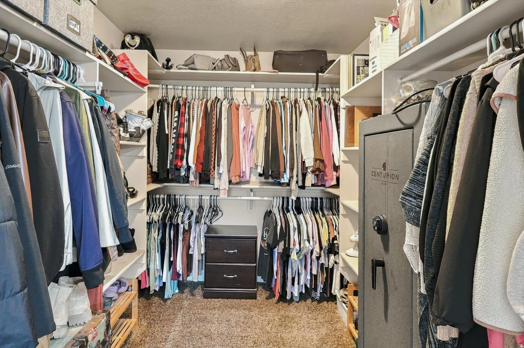 Custom closet system with multiple shelving units and hanging rods