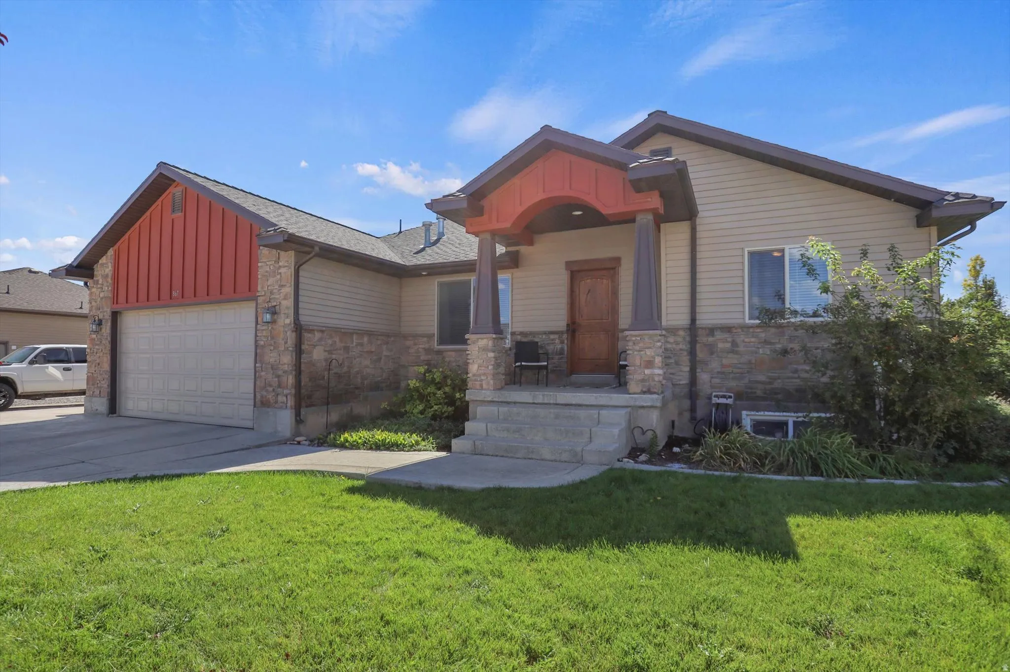 Stone facade accents with horizontal siding and vertical metal siding