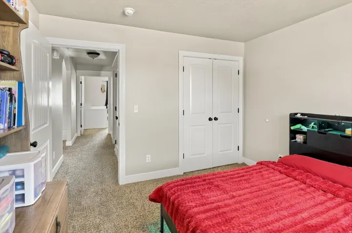 Carpeted flooring, neutral wall tones, and white trim throughout