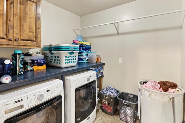 Built-in wood cabinetry, integrated countertop, and wall-mounted rod