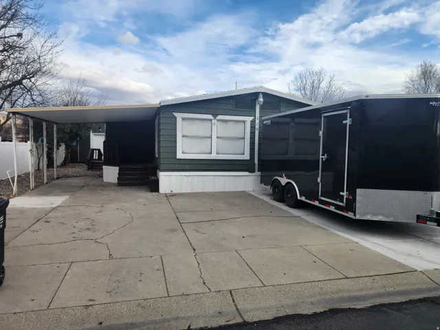 Covered carport with concrete driveway