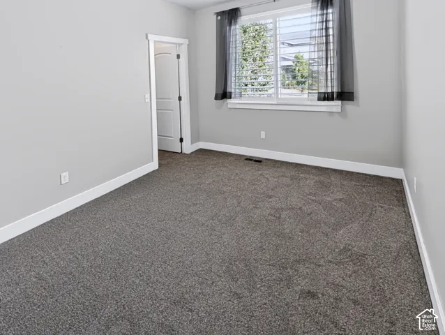 Neutral gray walls, white trim, and gray carpeting