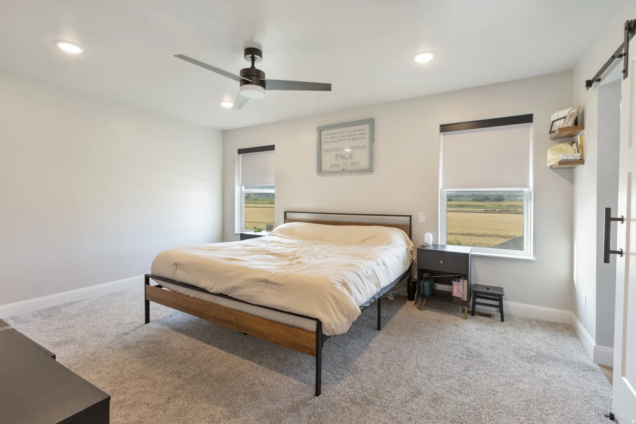 Recessed lighting, ceiling fan, and dual windows with roller shades