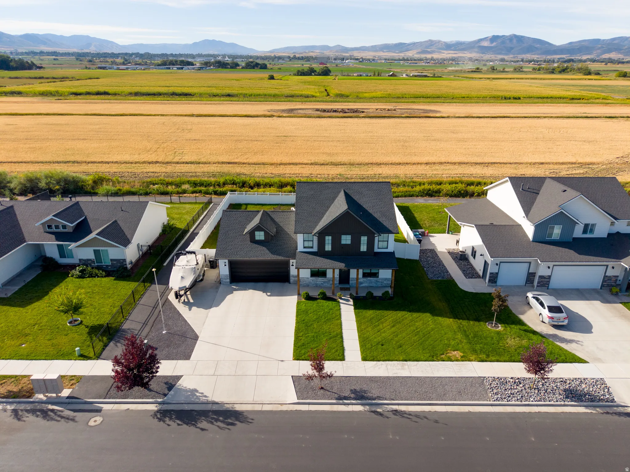Two-story residence with a dark facade, a two-car garage, and a concrete driveway