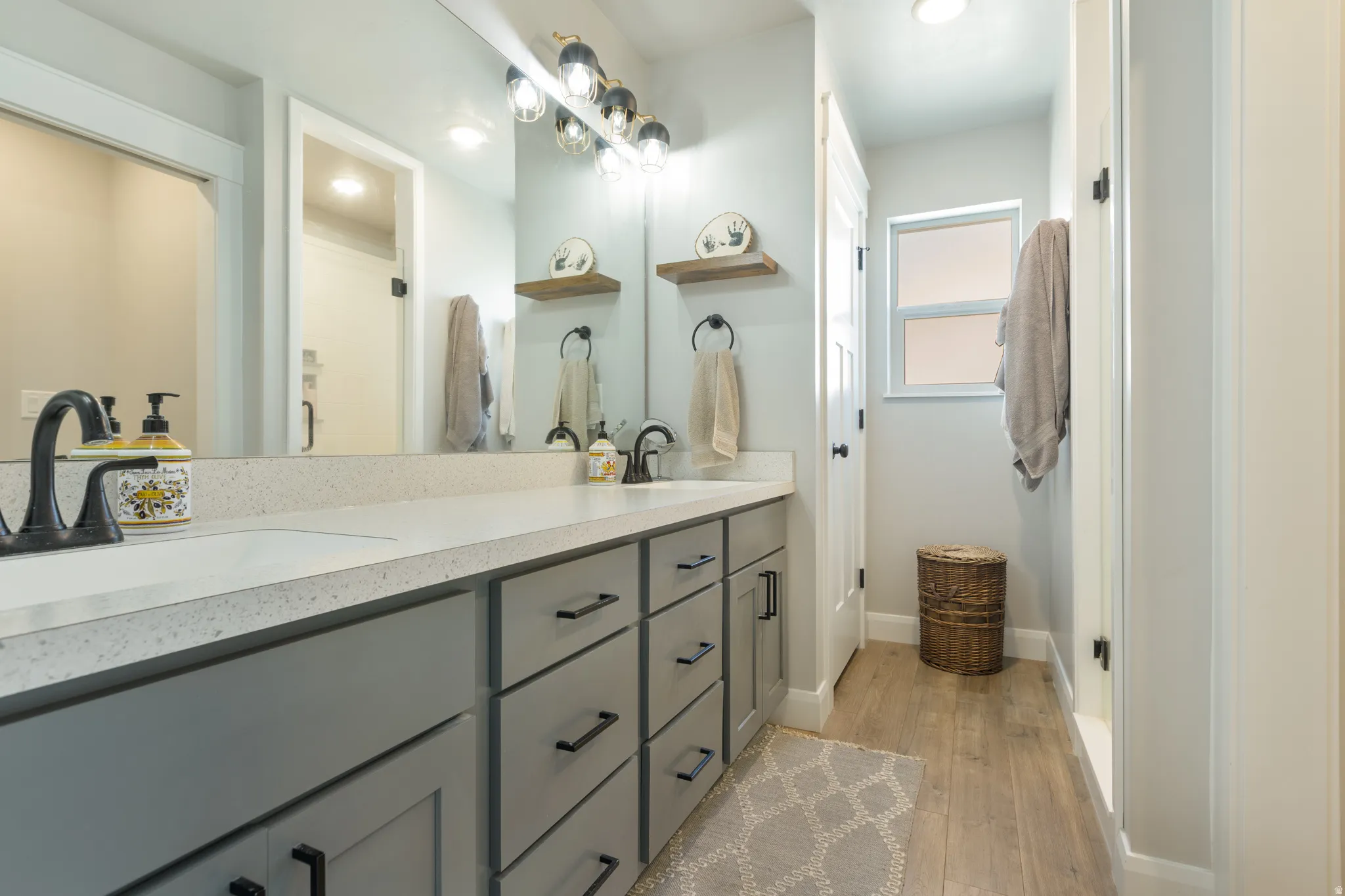 Dual vanity with undermount sinks and light-toned countertops