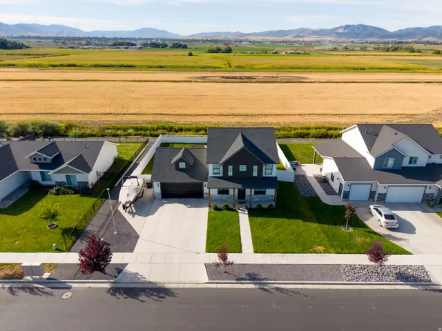 Two-story residence with a dark facade, a two-car garage, and a concrete driveway