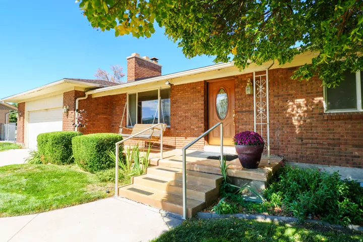 Brick exterior with a prominent chimney and an attached garage