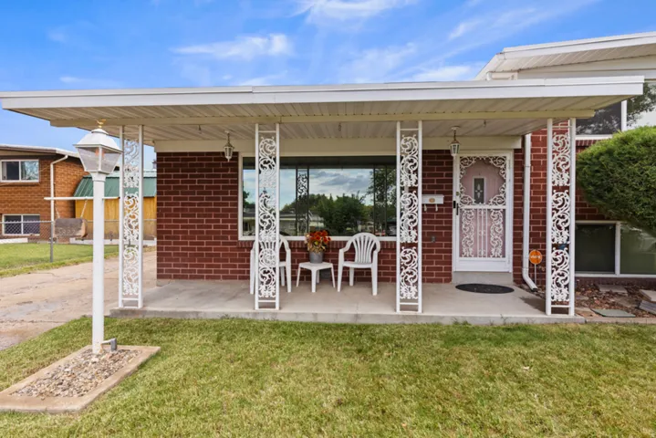 Brick home with a covered porch, decorative metal columns