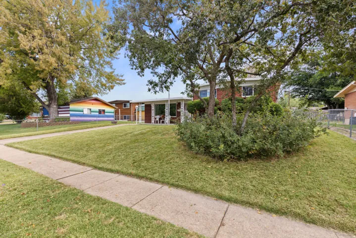 Brick home with a covered front porch entry, a garage, and an extended driveway