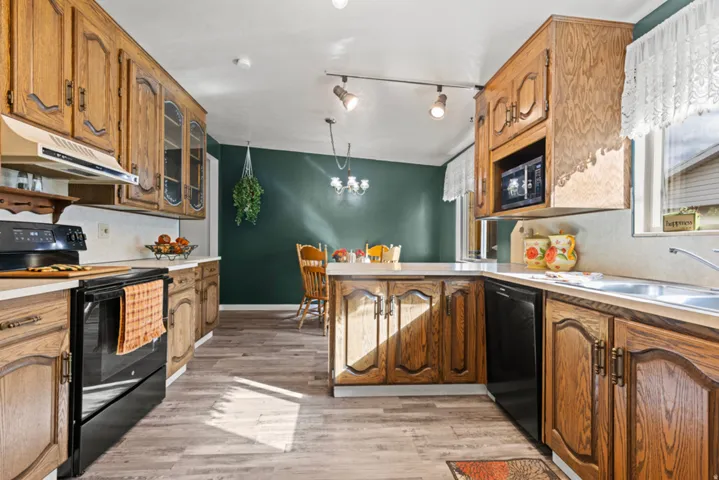 Kitchen featuring wood-finish cabinetry, solid surface countertops, and integrated appliances