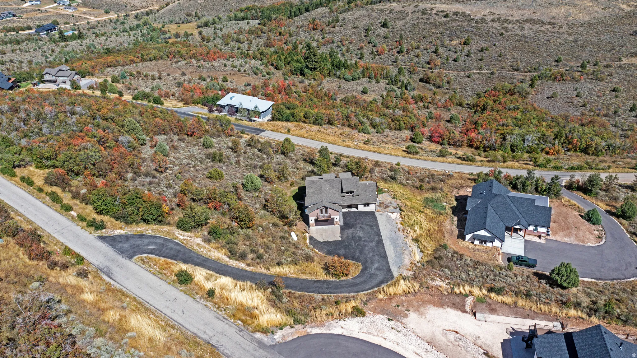 Expansive hillside lot featuring natural landscaping and paved road access