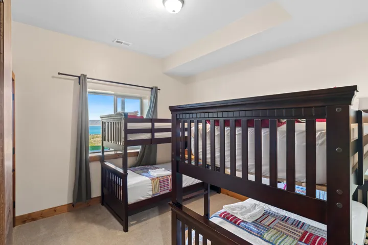 Carpeted flooring with wood trim and a window with a water backdrop
