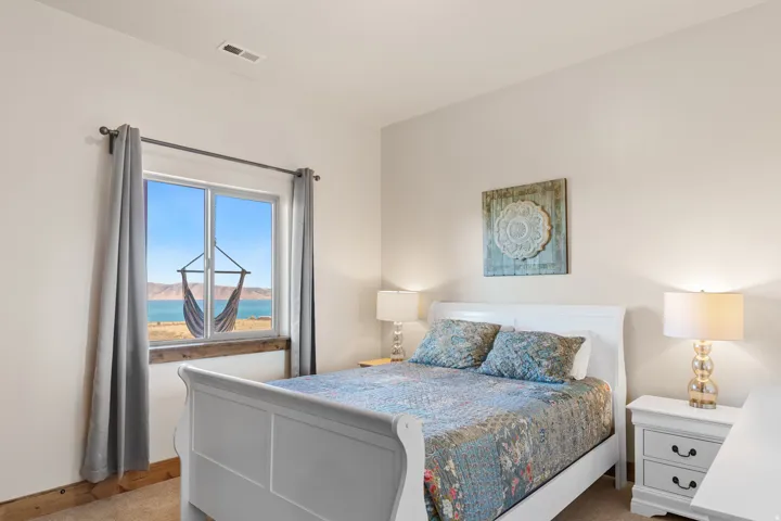 Window with a wood-finish sill, white walls, and carpeted flooring