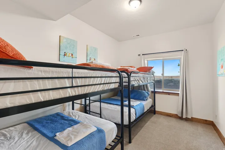 Carpeted flooring with wood-trim baseboards, window with wood-trim sill, and an overhead flush-mount light fixture