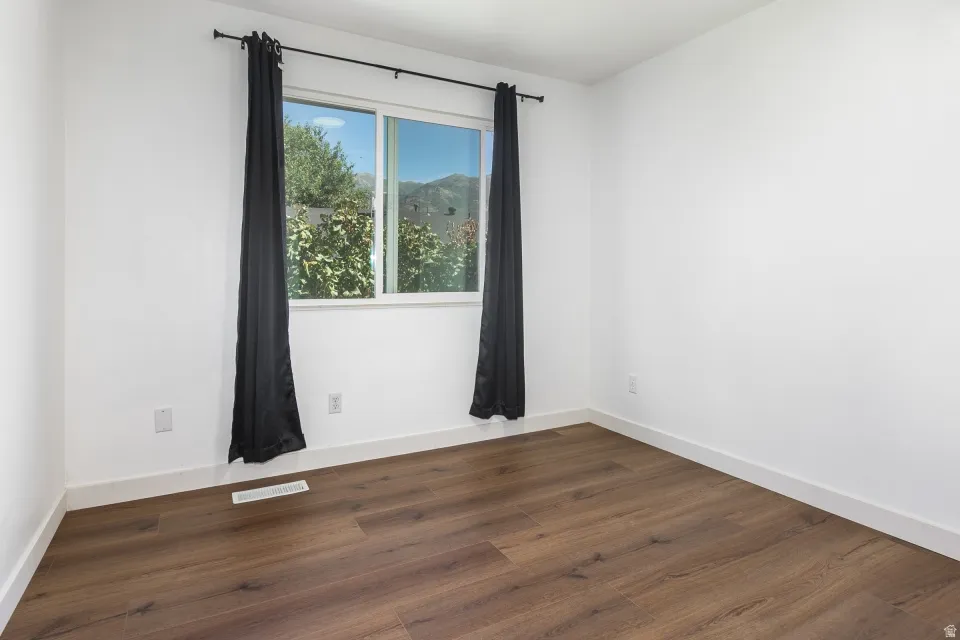 Wood-finish flooring with white baseboards