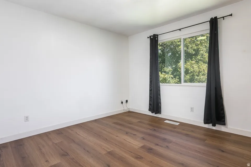 Wood-finish flooring with white walls and trim