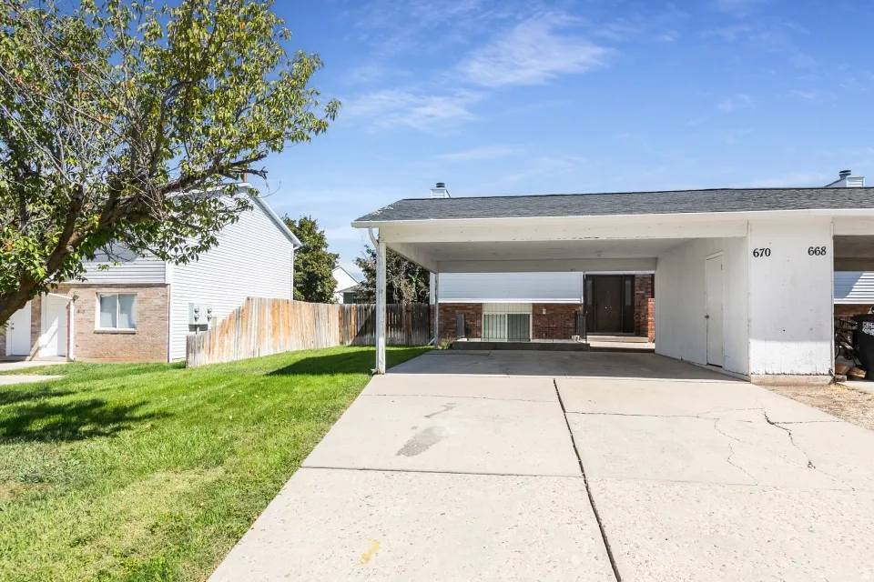 Carport with a paved concrete driveway
