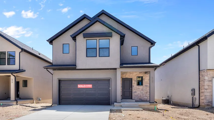 Modern two-story exterior with stucco finish and dark trim