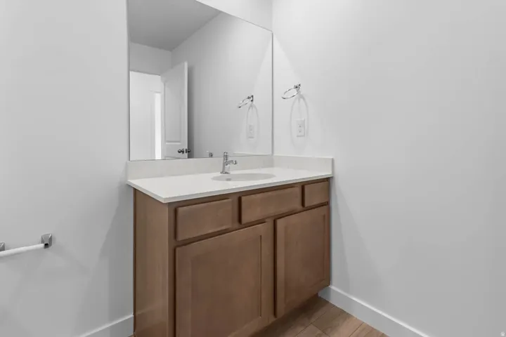 Vanity with a single basin, stainless steel faucet, and undermount sink