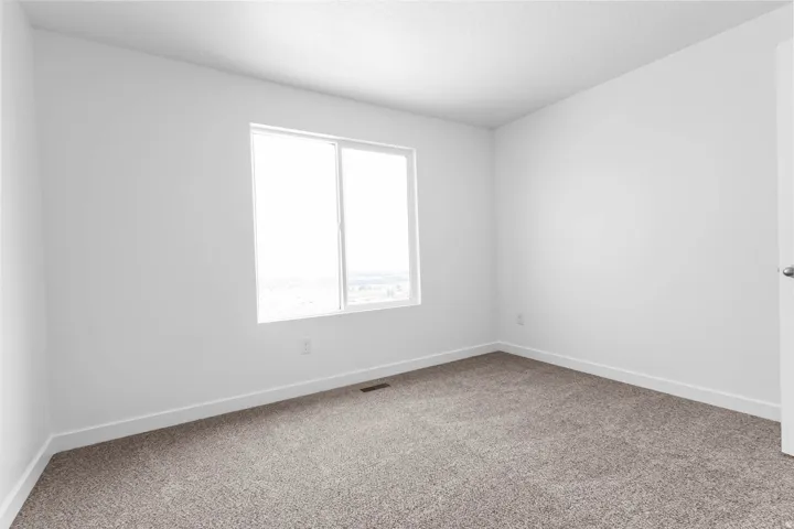 Neutral tone carpet with white baseboards