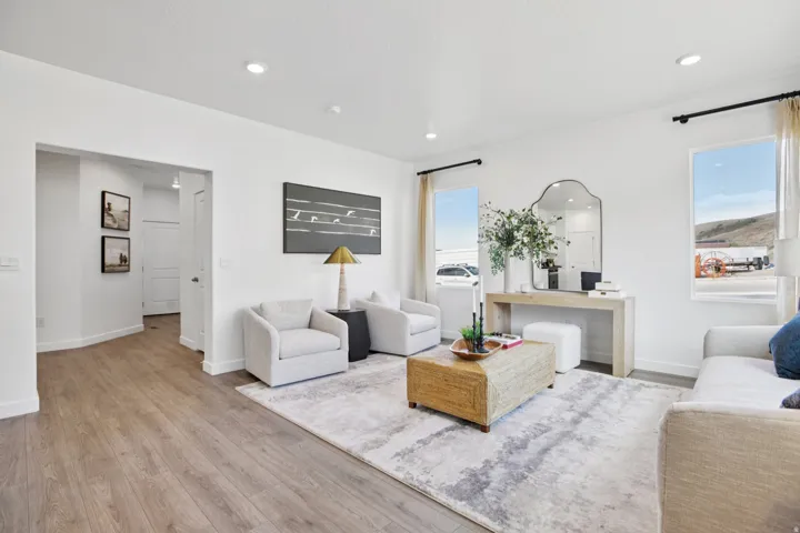 Recessed lighting, wood-finish flooring, and white walls