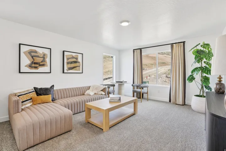 Recessed ceiling light, large window, and light gray carpeting