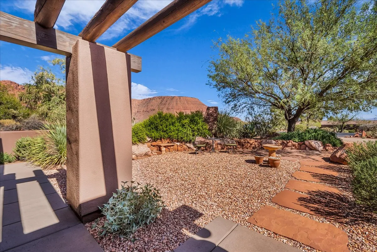 Outdoor Pergola with Exposed Wood Beams, Gravel Hardscaping, and a Stone Pathway