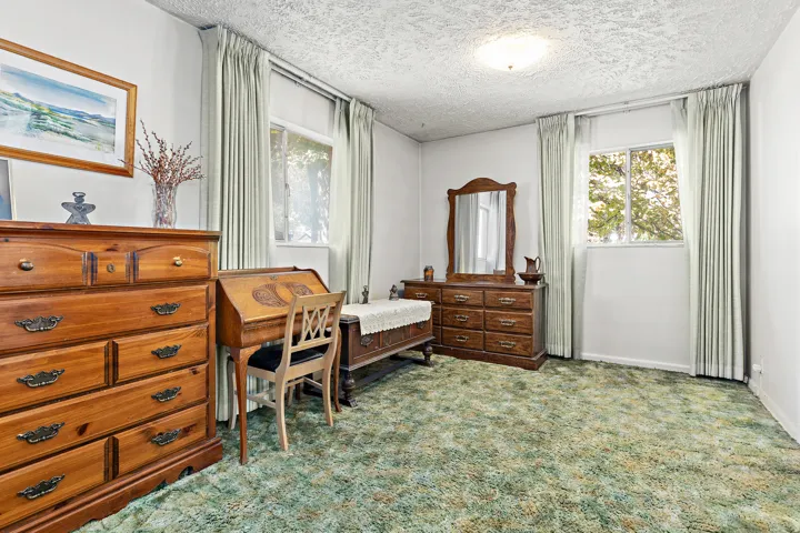 Primary bedroom and a window with blinds