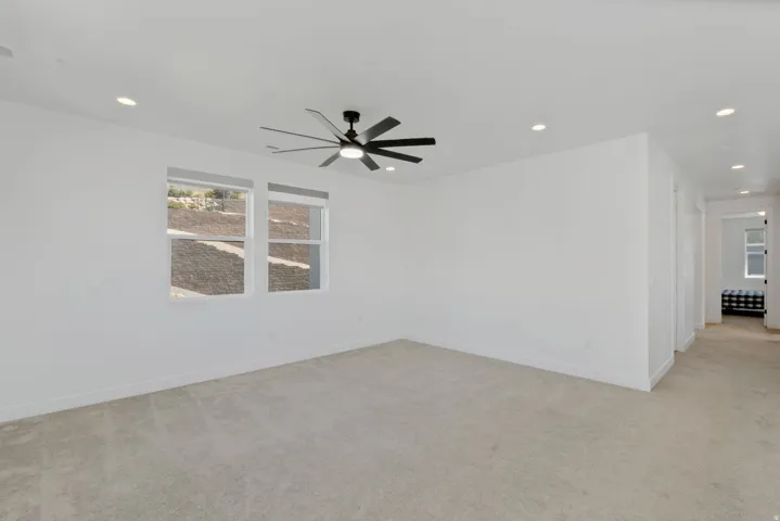 Spacious open room/ loft,  recessed lighting, and a modern ceiling fan