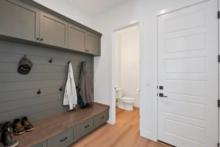Custom built-in storage bench with wood-finish top and dark cabinetry