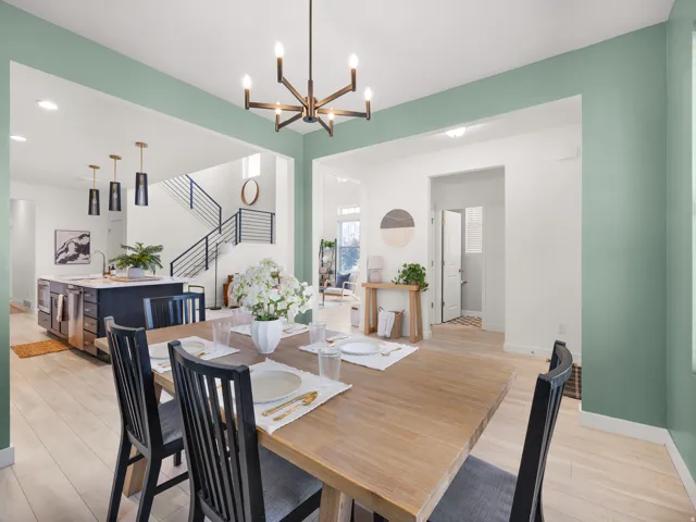 Open concept dining area with light wood-finish flooring