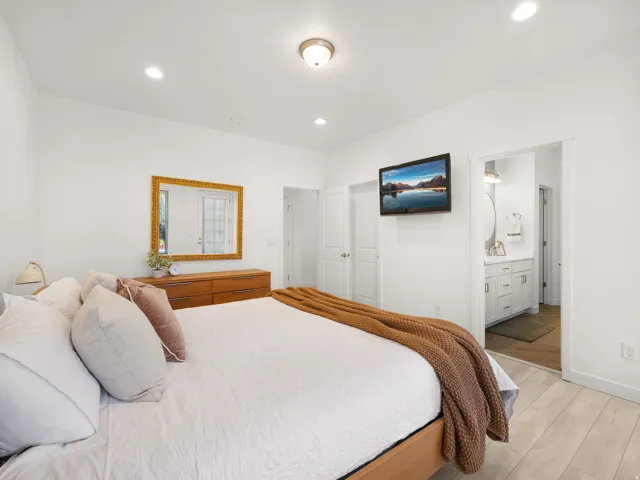 Recessed lighting, wood-finish flooring, and white walls