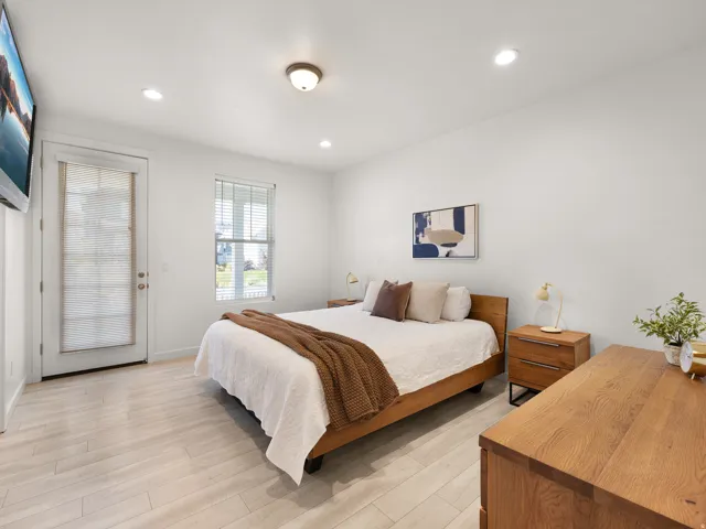 Wood-finish flooring, recessed lighting, and a window with blinds