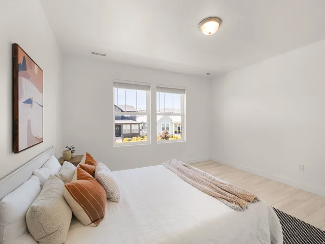 Neutral wall paint, light wood-finish flooring, and recessed ceiling lighting