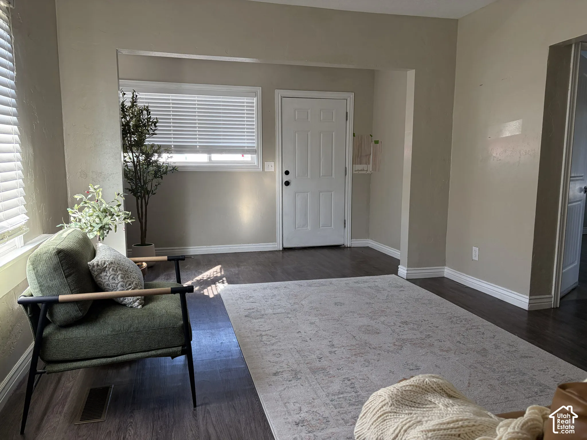 Wood-finish flooring throughout, white trim, and light wall tones