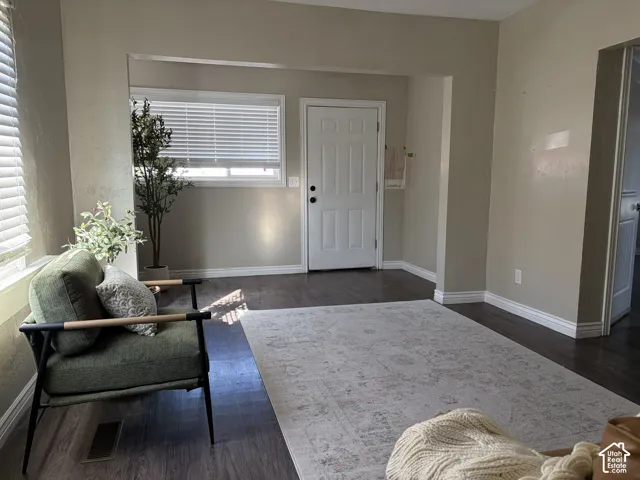 Wood-finish flooring throughout, white trim, and light wall tones