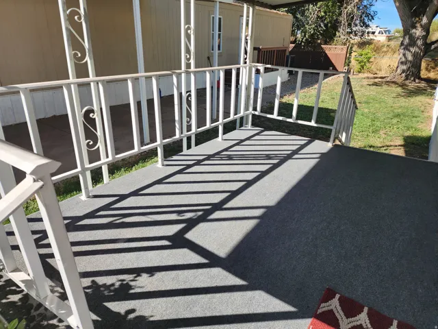 Covered porch with decorative metal railings